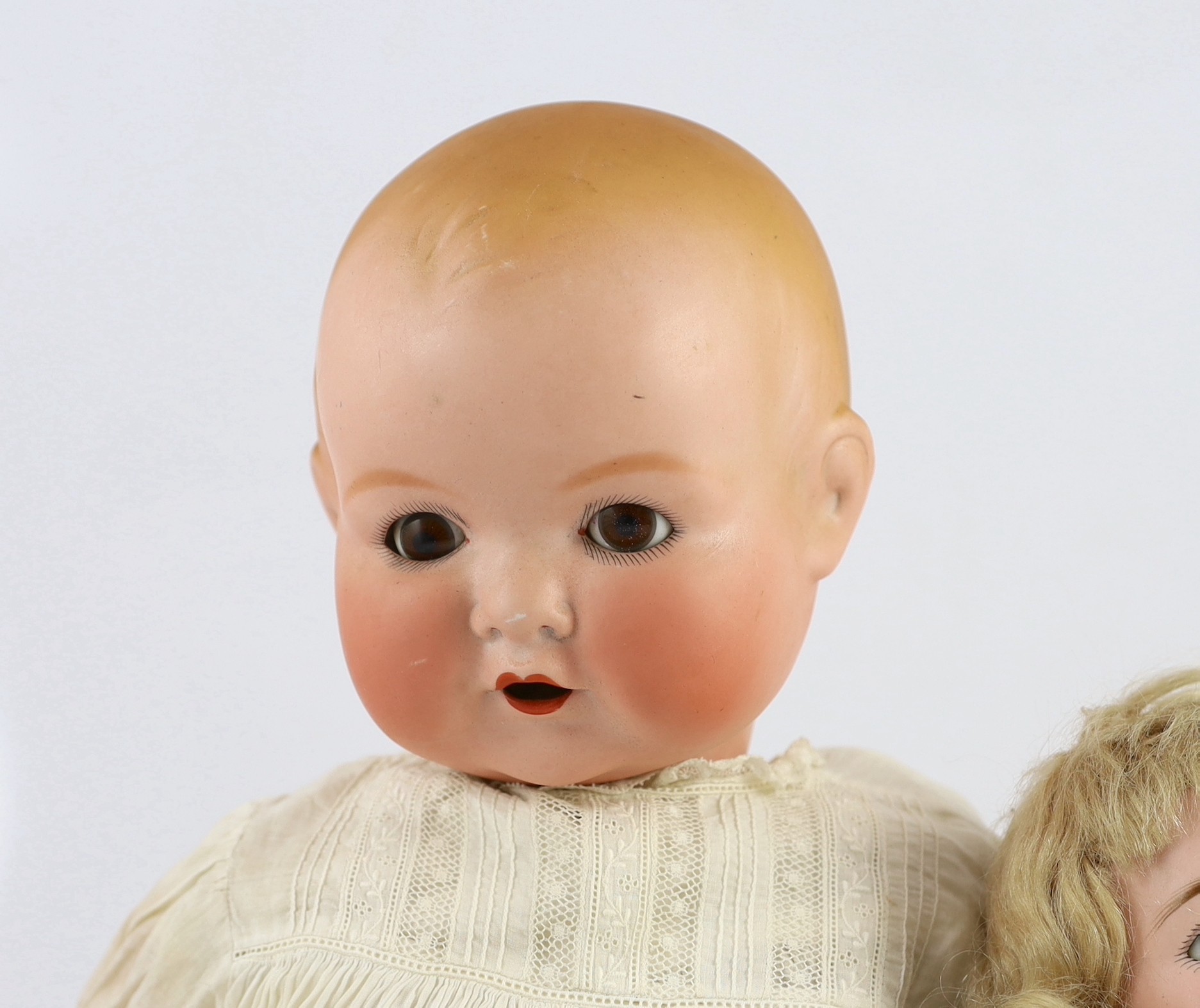 A Heinrich Handwerck bisque doll, German, circa 1900, 18in. and 23in. resp.